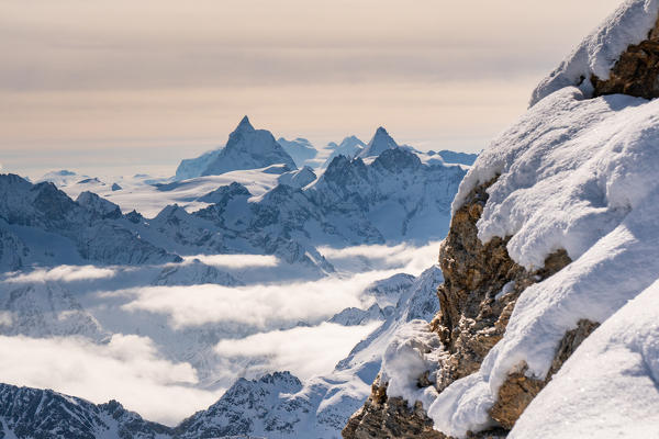 Matterhorn peak in background from La Sale peak in Valais mountains. Igloo refuge des Pantalons Blancs, Heremence, Sion, Valais canton, Switzerland, Europe.