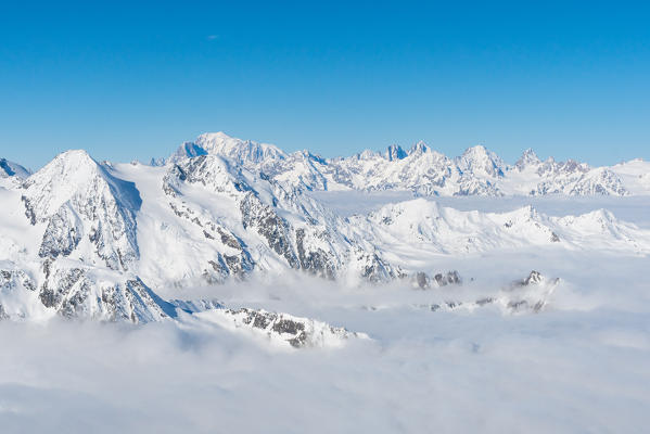 Mount Blanc in background over a clouy carpet from La Sale peak during winter. Igloo refuge des Pantalons Blancs, Heremence, Sion, Valais canton, Switzerland, Europe.