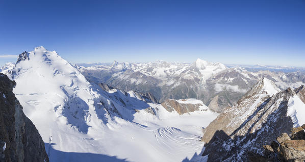 Panoramic view from Stecknadelhorn peak to Dom de Mischabel glacier and Zermatt valley in background. Zermatt, Vallese canton, Switzerland, Alps, Europe. 