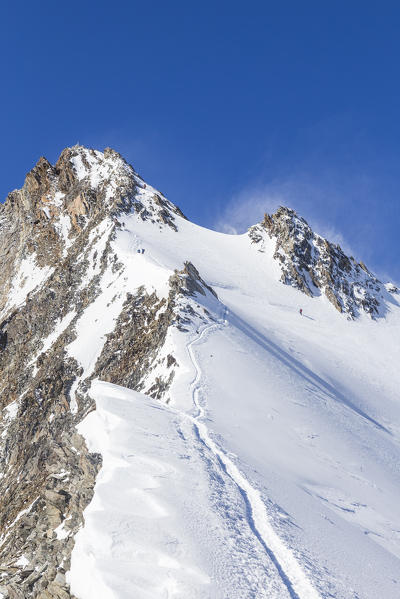 Alpinism in normal route to Nadelhorn mount. Sass Fe, Vallese canton, Switzerland, Alps, Europe.