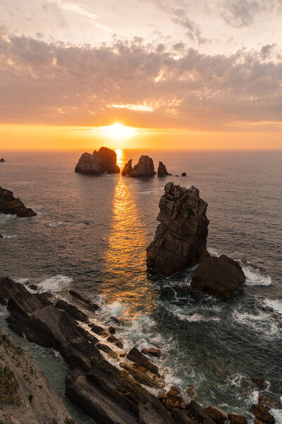 The rocky beach of Playa del Portio at sunset in the cantabrian sea. Costa Quebrada, Liencres, Cantabria, Spain, Europe.