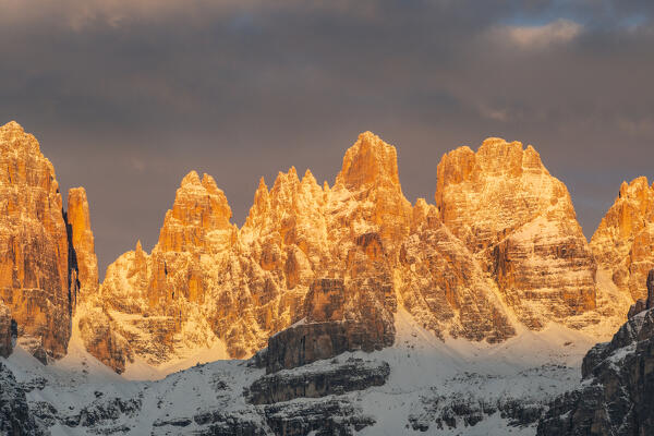 Mountain landscape of Brenta Dolomites peaks during a winter sunrise from Paganella, Trentino, Italy. 