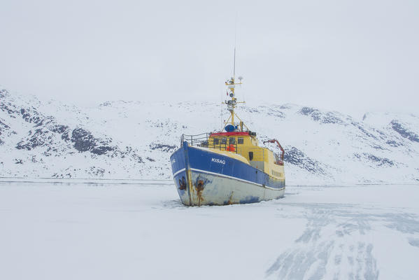 Boat in an iced fjord of West Coast of Greenland - Arctic sea - Denmark