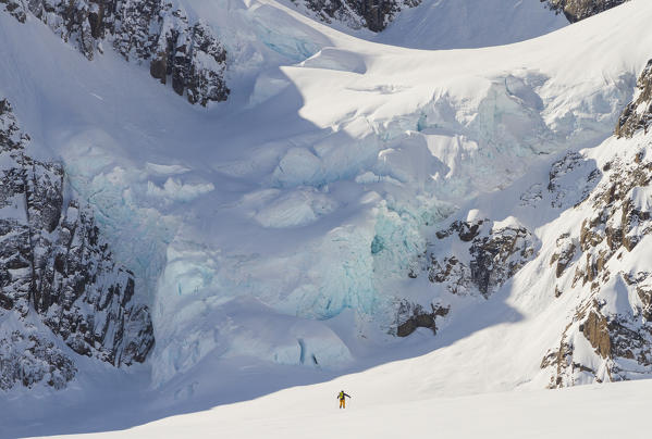 ski touring in the sight of a huge glacier. Greenland, Artic sea, Denmark