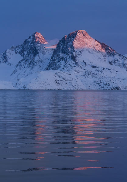Two peaks at sunset on a fjord of west coast of Greenland, Artic sea, Denmark