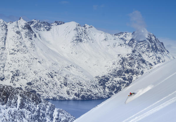 Ski touring in the montains over a fjord of west coast of Greenland, Artic sea, Denmark