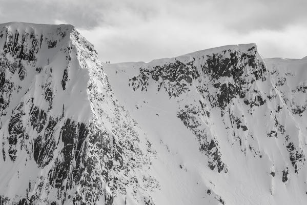 Three skiers ready for freeride descent, Golden, Alberta, British Columbia, Canada