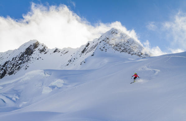 Skier during descent from Castor peak in winter, Roger pass, British Columbia, Canada
