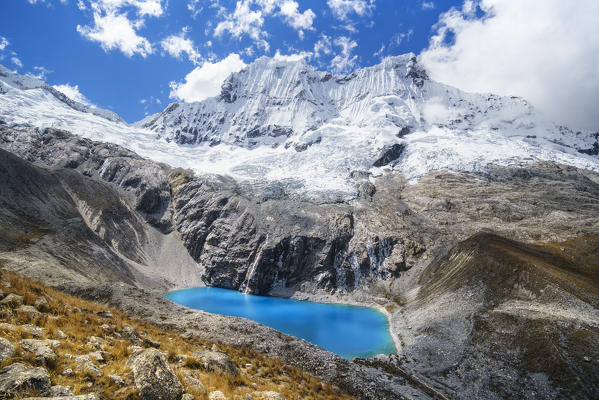 The blue lake of Laguna 69 with Chacraraju peak. Ancash, Cordigliera Blanca, Peru.