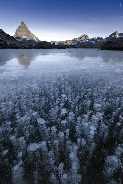 Ice bubbles in the Riffelsee Lake during a night of full moon. Zermatt, Mattertal, Canton of Valais, Switzerland, Europe