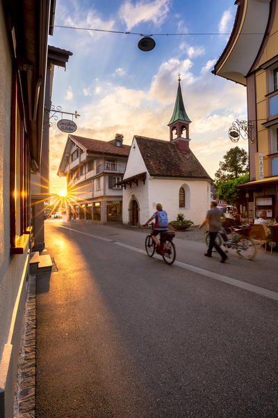 Two persons with bikes in the old town of Appenzell at sunset, Canton of Appenzell, Alpstein, Switzerland, Europe