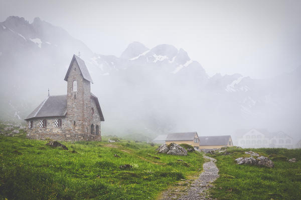 Fog wind up the pasture of Meglisalp ,Canton of Appenzell, Alpstein, Switzerland, Europe.