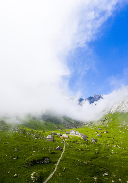 Sunlight filters between fog at the pasture of Meglisalp ,Canton of Appenzell, Alpstein, Switzerland, Europe