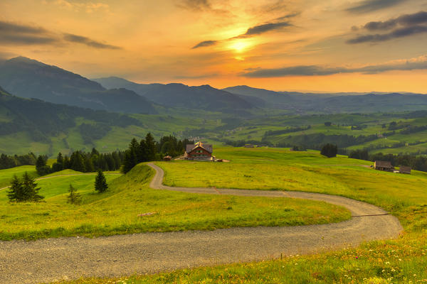 Winding road over the hills at sunset,Canton of Appenzell, Alpstein, Switzerland, Europe