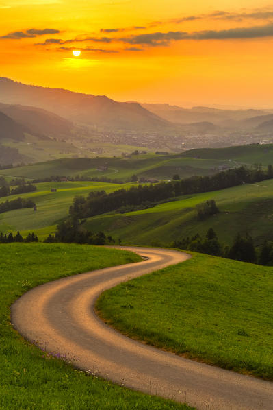 Winding road over the hills at sunset,Canton of Appenzell, Alpstein, Switzerland, Europe