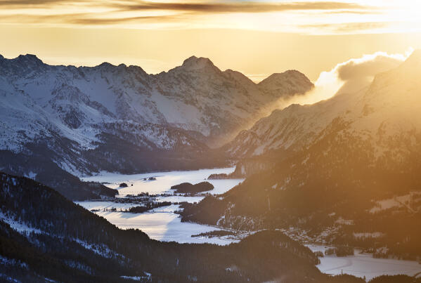 Elevated view of Engadine valley with lakes of Sils, Selvaplana and Sankt Morits covered by snow, at sunset. Graubunden Canton, Switzerland, Europe