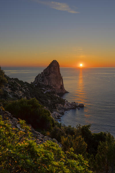 The sun is reflected on the sea surface at sunrise, Pedra Longa, Baunei, Ogliastra province, Sardinia, Italy, Europe