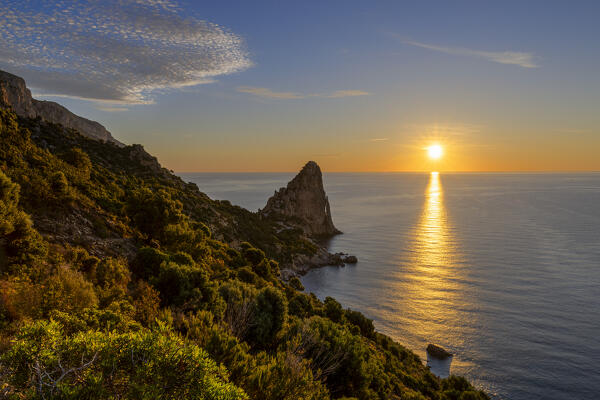 The sun is reflected on the sea surface at sunrise, Pedra Longa, Baunei, Ogliastra province, Sardinia, Italy, Europe
