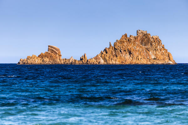 Red rocks against blue sea, Tancau beach, Latzorai, Ogliastra province,  Sardinia, Italy, Europe