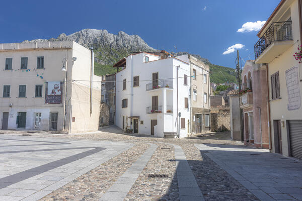 Santa Maria square in the old town of Oliena with traditional houses and Monte Corrasi in the background. Barbagia, Ogliastra province, Sardinia, Italy, Europe