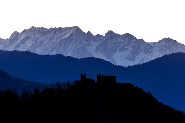 Grumello casle in the shadow with Adamello group in the background, Valtellina, Lombardy, Italy, Europe
