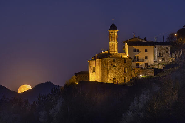 Sunset of moon with Sassella Sanctuary in the foreground, Valtellina, Lombardy, Italy, Europe