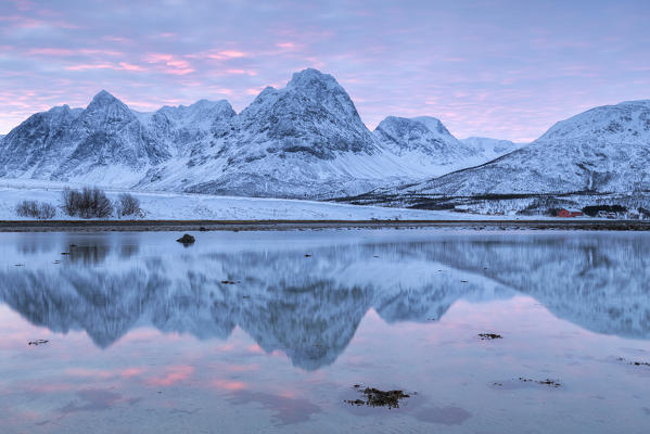 Rakeltinden is reflected in the fjord. Storsteinnes, Balsfjorden, Lyngen Alps, Troms, Norway, Lapland, Europe.
