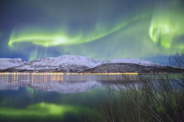 Northern Lights is reflected in Kafjorden. Kafjorden, Lyngen Alps, Troms, Norway, Lapland, Europe.