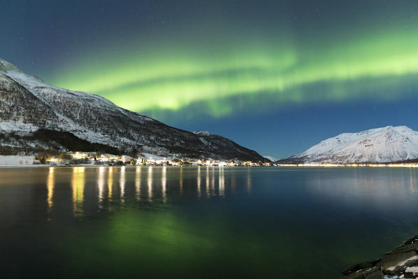 Northern lights over the fjord. Lokvoll, Manndalen, Kafjord, Lyngen Alps, Troms, Norway, Lapland, Europe.