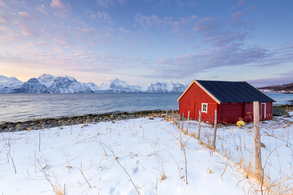 A traditional house overlooking the fjord. Nordmannvik, Kafjord, Lyngen Alps, Troms, Norway, Lapland, Europe.