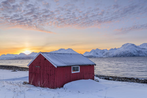 Traditional red fisherman's house. Nordmannvik, Kafjord, Lyngen Alps, Troms, Norway, Lapland, Europe.