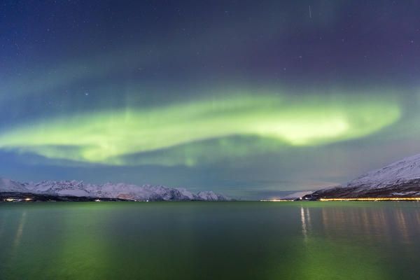 Northern lights over the fjord. Skivahollet, Kafjord, Lyngen Alps, Troms, Norway, Lapland, Europe.