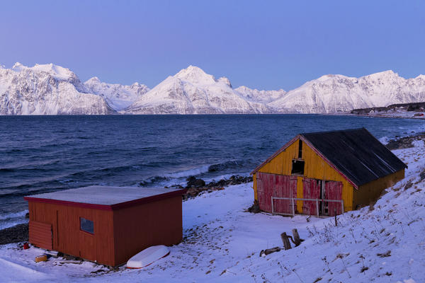 Typical houses of fishermen during twilight. Hammarvika, Lyngenfjord, Lyngen Alps, Troms, Norway, Lapland, Europe.