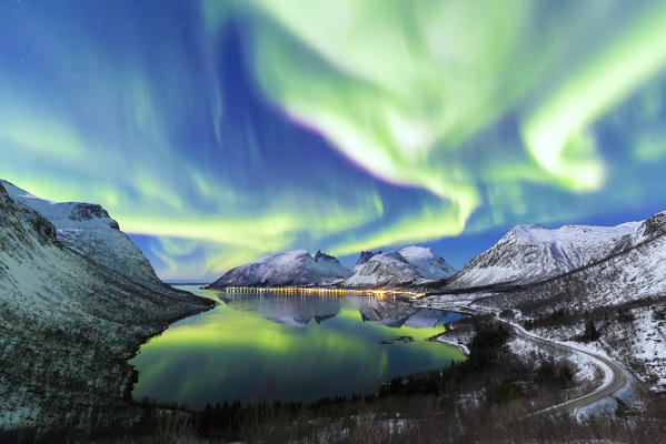 Northern lights in the night sky from panoramic point over Bergsfjorden. Bergsfjorden, Senja, Norway, Europe.