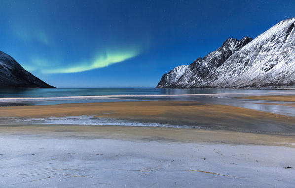 Northern lights in the night sky over Ersfjord Beach. Ersfjord, Ersfjorden, Senja, Norway, Europe.
