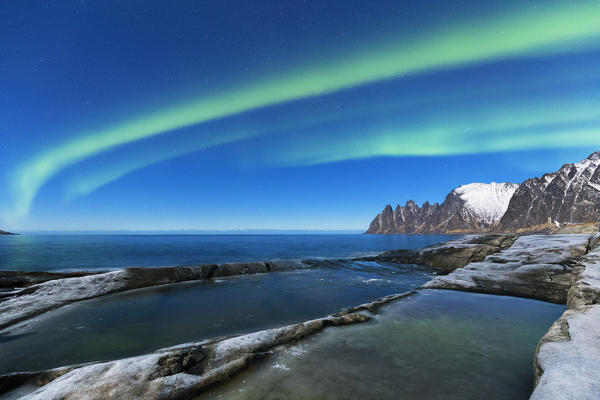 Northern lights above the bay facing Tungeneset.  Tungeneset, Ersfjorden, Senja, Norway, Europe.