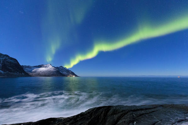 Northern lights above Steinfjorden. Tungeneset, Ersfjorden, Senja, Norway, Europe.