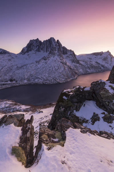 Mefjorden illuminated by the colors of the arctic sunset. Barden, Mefjordbotn, Mefjorden, Senja, Norway, Europe.
