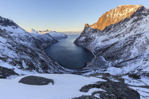 View of Oyfjorden during the last sun illuminating the peaks. Barden, Mefjordbotn, Mefjorden, Senja, Norway, Europe.