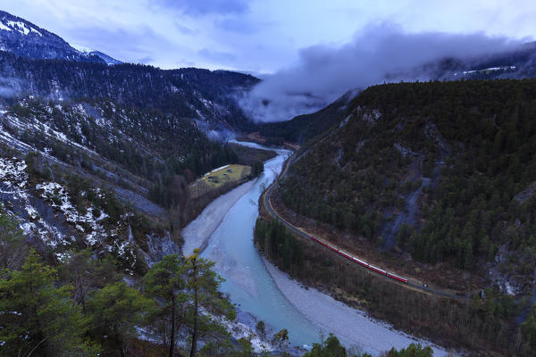 Transit of the Red Train in the gorge. Rhein Gorge(Ruinaulta), Flims, Imboden, Graubunden, Switzerland, Europe
