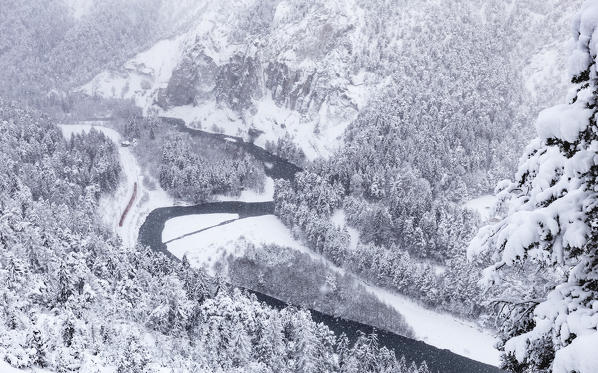 The Red Train passes in the gorge despite heavy snow. Rhein Gorge(Ruinaulta), Flims, Imboden, Graubunden, Switzerland, Europe