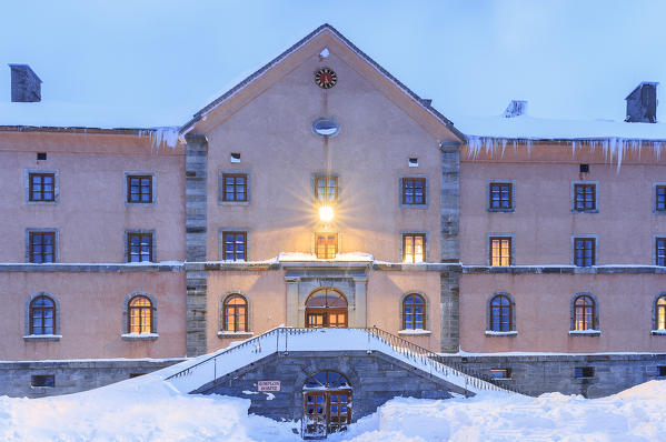 Facade of the Simplon Pass Hospice during twilight. Simplon Pass, Canton of  Valais/Wallis, Switzerland.