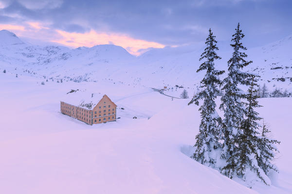 Hospice of the Simplon pass illuminated by the warm sunset light. Simplon Pass, Canton of  Valais/Wallis, Switzerland.