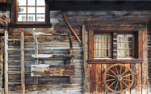 wall of a traditional house in the historic center of Zermatt with exposed ancient objects. Zermatt,  Canton of Valais / Wallis, Switzerland.