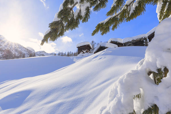 Traditional sunlit huts of Blatten. Zermatt, Canton of Valais / Wallis, Switzerland.