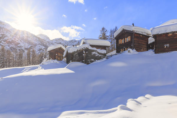 Traditional sunlit huts of Blatten. Zermatt, Canton of Valais / Wallis, Switzerland.