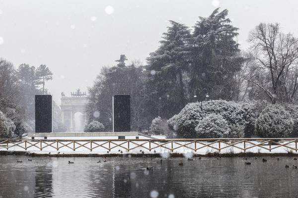 Snowfall in Sempione Park with Arch of Peace in the background. Milan, Lombardy, Northern Italy, Italy.