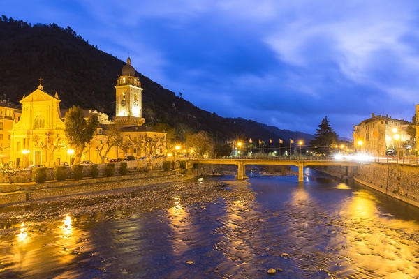 The lights are reflected in the river during twilight. Dolceacqua, Province of Imperia, Liguria, Italy, Europe.