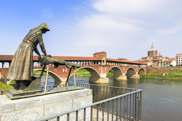 Lavandaia statue with the Ponte Coperto in the background. Pavia, Pavia province, Lombardy, Italy, Europe.