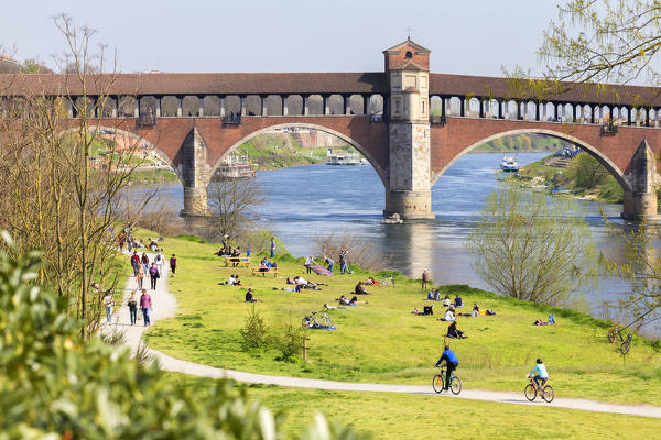 People at the Ponte Coperto. Pavia, Pavia province, Lombardy, Italy, Europe.